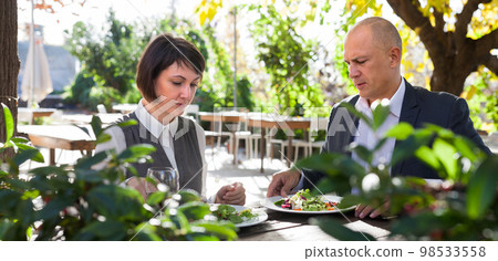 Couple in love eating dinner at restaurant summer terrace 98533558