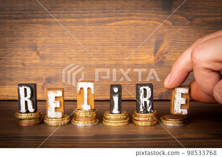 Retire Concept. Alphabet blocks and change on wooden background Retire Concept. Alphabet blocks and change on wooden background 98533768