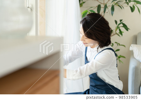 middle woman cleaning windows 98533905