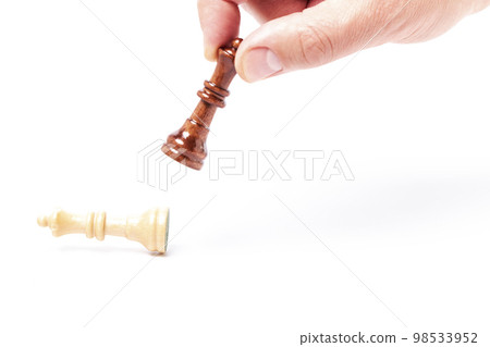 Business man knocking down white queen with black queen on white background Business man knocking down white queen with black queen on white background 98533952