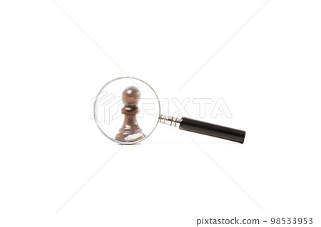 Magnifying glass enlarging a black pawn on white background Magnifying glass enlarging a black pawn on white background 98533953