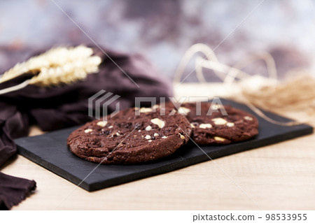 Freshly homemade chocolate cookies on a chalkboard Freshly homemade chocolate cookies on a chalkboard 98533955