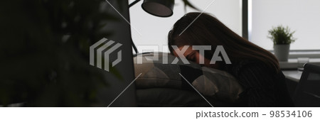 Freelance woman exhausted by hard work is sleeping in office Freelance woman exhausted by hard work is sleeping in office 98534106