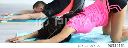 Man and woman do exercises for spine in gym 98534161