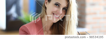 Portrait of a beautiful smiling businesswoman in workplace. Portrait of a beautiful smiling businesswoman in workplace. 98534195