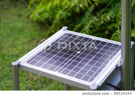 New Solar Cell is laid down among tree plant in the garden. 98534343
