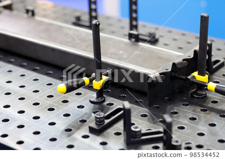 workpieces on a welding table with clamps workpieces on a welding table with clamps 98534452