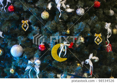 Part of a Christmas tree decorated with colorful toys. Part of a Christmas tree decorated with colorful toys. 98534526