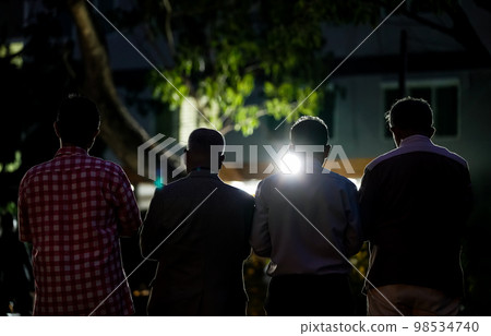 worship of the Allah's kindness by four middle age man in the garden at night time 98534740