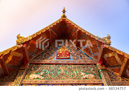 A front roof of Buddhist Temple at Wat Phra That Doi Tung, a famous Temple and Buddhism place. It's settled on the mountain in Chiang Rai province, north of Thailand. 98534757