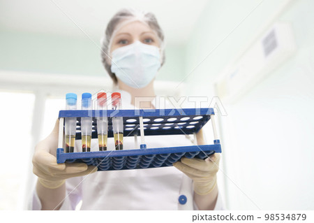 Blood transfusion station.Nurse with blood tests.Blood in test tubes. Blood transfusion station.Nurse with blood tests.Blood in test tubes. 98534879