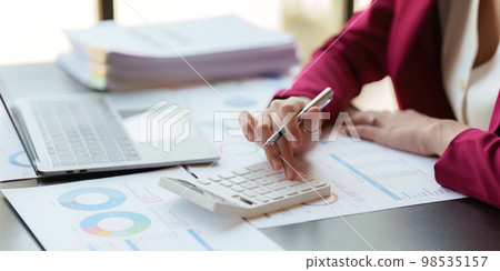 Asian Business woman working at home office and analyze financial report document. Accounting and Finance concept 98535157