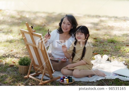 Asian Grandmother and Granddaughter having activity together outdoor park. Hobbies and leisure, lifestyle, family life, happiness moment concept 98535165