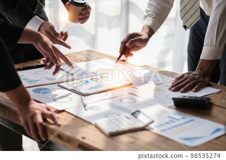 Close up of Diverse colleagues gather brainstorm discuss financial statistics at office meeting. finance, teamwork concept Close up of Diverse colleagues gather brainstorm discuss financial statistics at office meeting. finance, teamwork concept 98535274