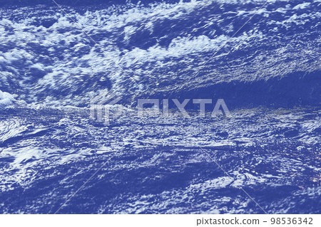 Pure mineral blue water flows over stepped mountain stones Pure mineral blue water flows over stepped mountain stones 98536342