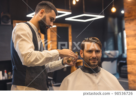 Barber trimming shaving cleints neck with electric razor Barber trimming shaving cleints neck with electric razor 98536726