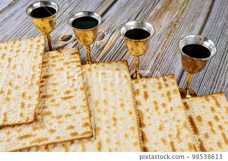 Passover matzo Jewish holiday celebration of matzah with four cups red kosher wine served during kiddush Passover matzo Jewish holiday celebration of matzah with four cups red kosher wine served during kiddush 98538613