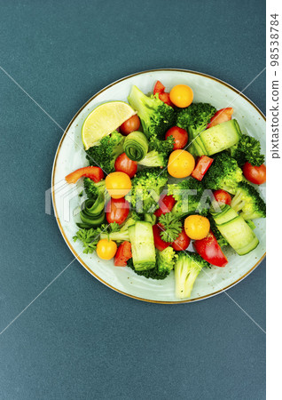 Spring vegetable salad decorated with physalis. Spring vegetable salad decorated with physalis. 98538784