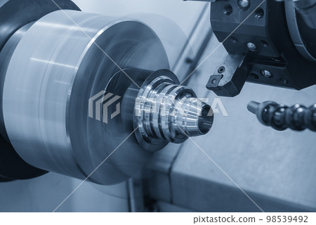 The CNC lathe machine forming cutting the metal cone shape parts. The CNC lathe machine forming cutting the metal cone shape parts. 98539492