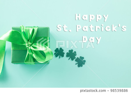 Happy St Patricks Day decoration background concept. shamrocks leaves holiday symbol with copy space on pastel background, above view gift box green clover leaves Happy St Patricks Day decoration background concept. shamrocks leaves holiday symbol with copy space on pastel background, above view gift box green clover leaves 98539886