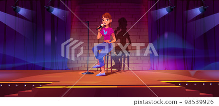 Female stand-up comedian performing on stage 98539926