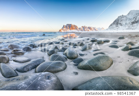 Astonishing winter scenery on Uttakleiv beach at sunset time. Astonishing winter scenery on Uttakleiv beach at sunset time. 98541367