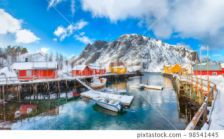 Stunning morning seascape of Norwegian sea and cityscape of Nusfjord village. Stunning morning seascape of Norwegian sea and cityscape of Nusfjord village. 98541445