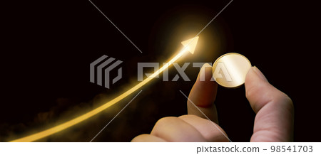 A hand holding gold coin and growing golden arrow with dark black background A hand holding gold coin and growing golden arrow with dark black background 98541703