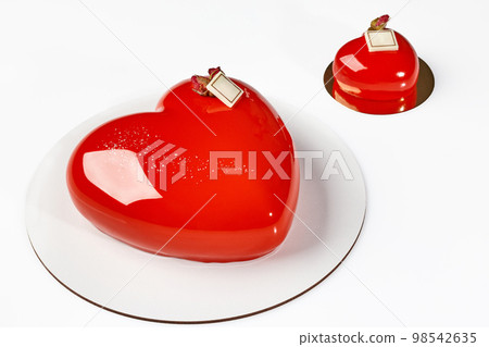 Mousse cake and pastry in shape of hearts with glossy red glaze Mousse cake and pastry in shape of hearts with glossy red glaze 98542635