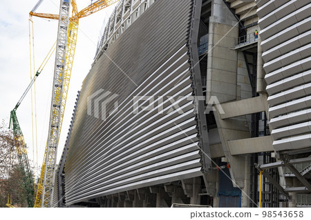 Santiago Bernabeu. Exterior of the Santiago Bernabeu stadium in full works and renovation of the venue where Real Madrid C.F. Football field. Field full of machines. MADRID, SPAIN - JANUARY 24, 2023. Santiago Bernabeu. Exterior of the Santiago Bernabeu stadium in full works and renovation of the venue where Real Madrid C.F. Football field. Field full of machines. MADRID, SPAIN - JANUARY 24, 2023. 98543658