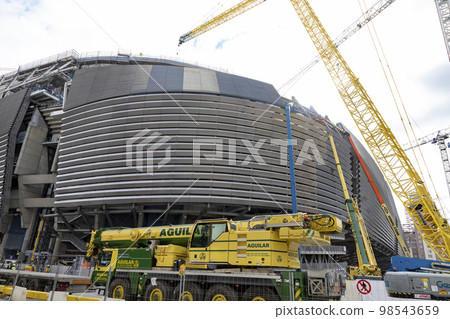 Santiago Bernabeu. Exterior of the Santiago Bernabeu stadium in full works and renovation of the venue where Real Madrid C.F. Football field. Field full of machines. MADRID, SPAIN - JANUARY 24, 2023. Santiago Bernabeu. Exterior of the Santiago Bernabeu stadium in full works and renovation of the venue where Real Madrid C.F. Football field. Field full of machines. MADRID, SPAIN - JANUARY 24, 2023. 98543659