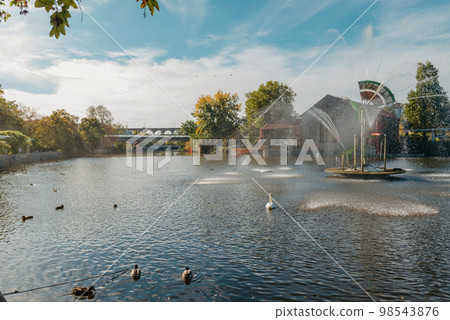 City fountain and pond with swan and ducks in Old European City Bietigheim-Bissingen In Germany. the City Park of Bietigheim-Bissingen, Baden-Wuerttemberg, Germany, Europe. Autumn Park and nature City fountain and pond with swan and ducks in Old European City Bietigheim-Bissingen In Germany. the City Park of Bietigheim-Bissingen, Baden-Wuerttemberg, Germany, Europe. Autumn Park and nature 98543876