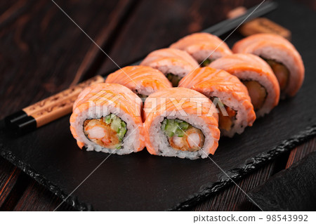 Sushi roll philadelphia with crab and cucumber and cream cheese, caviar on black background close-up. Sushi menu. Japanese food concept 98543992
