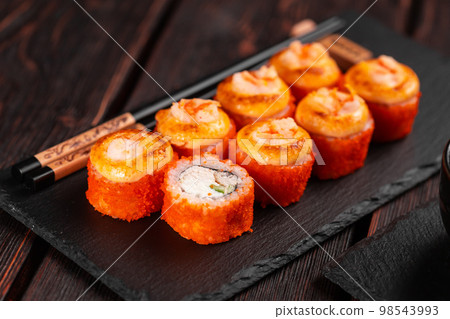 California sushi roll with crab cucumber and tobiko caviar served on black board close-up - Japanese asian food 98543993