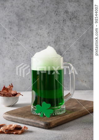 Patrick's day green beer in pint and jerky on gray background. 98544007
