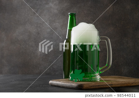 Patrick's day green beer in pint on dark background. Shamrock symbol of luck. 98544011