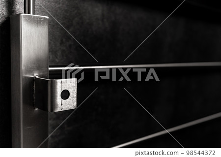 stainless steel railings on a dark background stainless steel railings on a dark background 98544372
