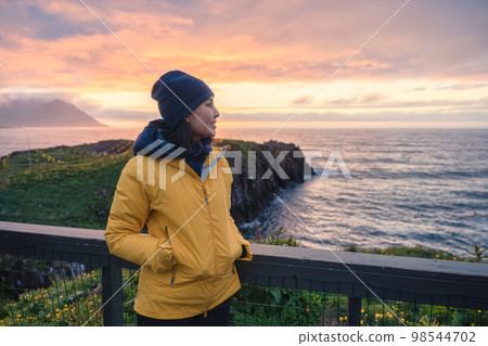 Young asian woman standing and watching puffin bird on the cliff in Borgarfjordur Eystri Young asian woman standing and watching puffin bird on the cliff in Borgarfjordur Eystri 98544702