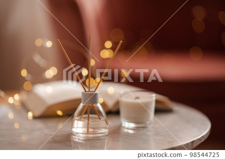 Home liquid fragrance with candles on table in room Home liquid fragrance with candles on table in room 98544725