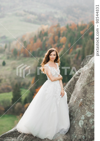 Beauty woman, bride with perfect white dress background mountains Beauty woman, bride with perfect white dress background mountains 98544831