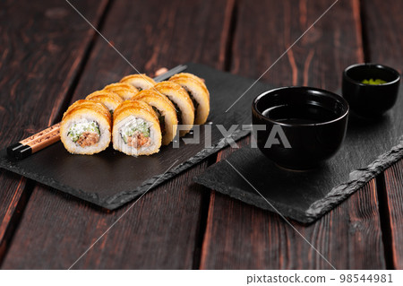 Sushi roll with smoked tuna with cucumber and cheese close-up. Traditional delicious fresh sushi roll set. Sushi menu. Japanese cuisine restaurant. Asian food 98544981
