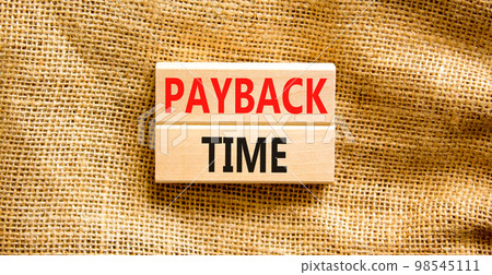Payback time symbol. Concept words Payback time on wooden blocks. Beautiful canvas table canvas background. Business and payback time concept. Copy space. Payback time symbol. Concept words Payback time on wooden blocks. Beautiful canvas table canvas background. Business and payback time concept. Copy space. 98545111