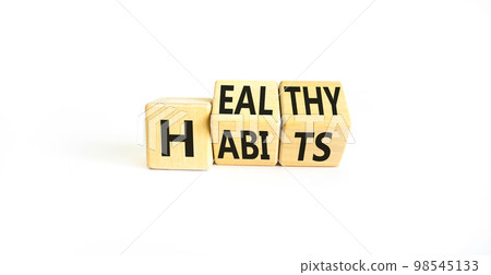 Healthy habits symbol. Concept words Healthy habits on wooden cubes. Beautiful white table white background. Medical and healthy habits concept. Copy space. 98545133