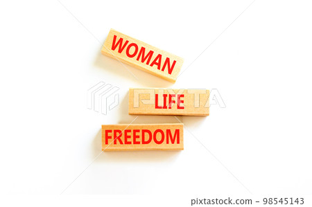 Woman life freedom symbol. Concept words Woman Life Freedom on wooden blocks on a beautiful white table white background. Social issue woman life freedom concept. Copy space. Woman life freedom symbol. Concept words Woman Life Freedom on wooden blocks on a beautiful white table white background. Social issue woman life freedom concept. Copy space. 98545143