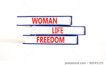 Woman life freedom symbol. Concept words Woman Life Freedom on books on a beautiful white table white background. Social issue woman life freedom concept. Copy space. Woman life freedom symbol. Concept words Woman Life Freedom on books on a beautiful white table white background. Social issue woman life freedom concept. Copy space. 98545155