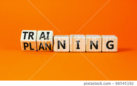 Training and planning symbol. Concept word Training and Planning on wooden cubes. Beautiful orange table orange background. Business training and planning concept. Copy space. 98545192