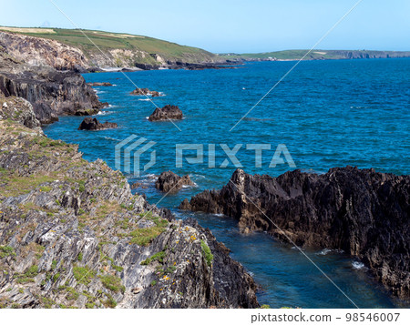 Irish sea landscape. Rocky coast of the Atlantic. The blue sea, mountain beside body of water. Irish sea landscape. Rocky coast of the Atlantic. The blue sea, mountain beside body of water. 98546007