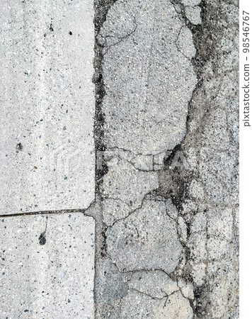 Pot hole and cracks in a road caused by heavy industrial loads 98546767