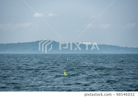 Lobster pot trap buoy floating on a choppy ocean in the Atlantic Ocean 98546832