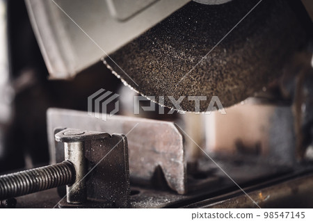 Selective focus on chop saw abrasive blade used for cutting metal. Selective focus on chop saw abrasive blade used for cutting metal. 98547145